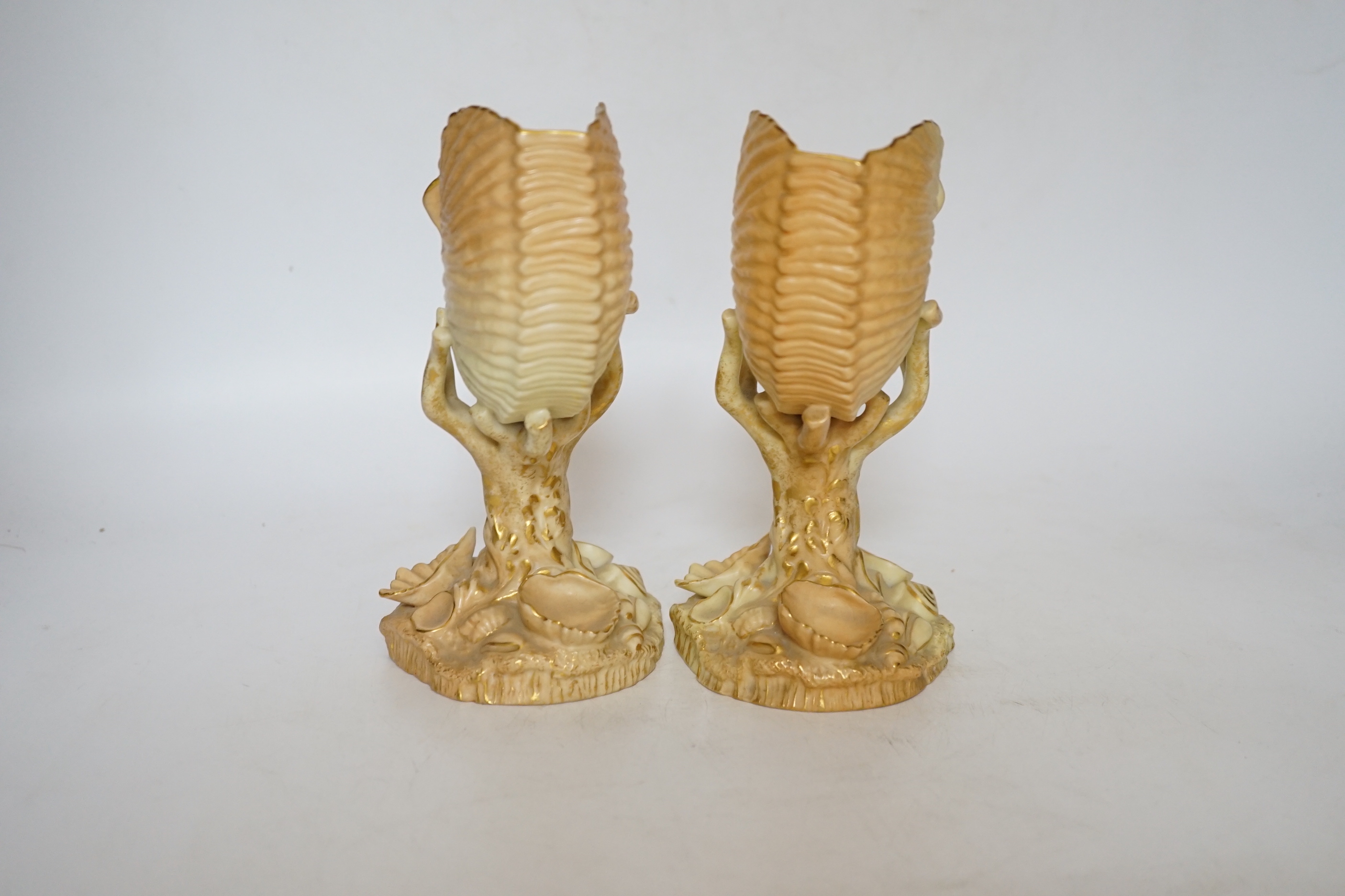 A pair of Royal Worcester blush ivory nautilus shell spill vases, 17cm